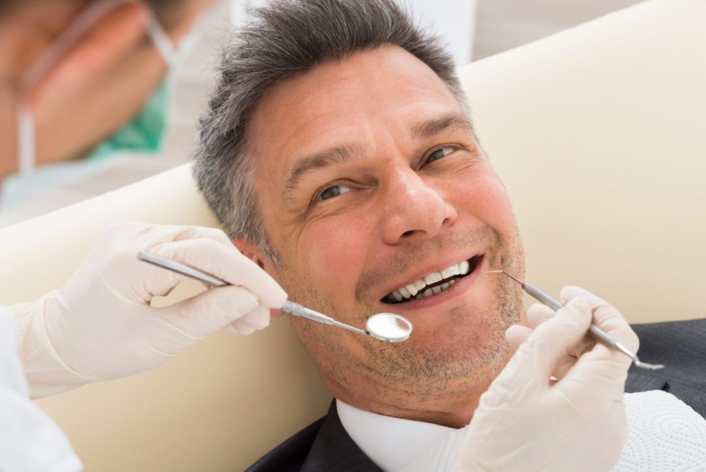 Man Having Restorative Dental Work in Northborough MA